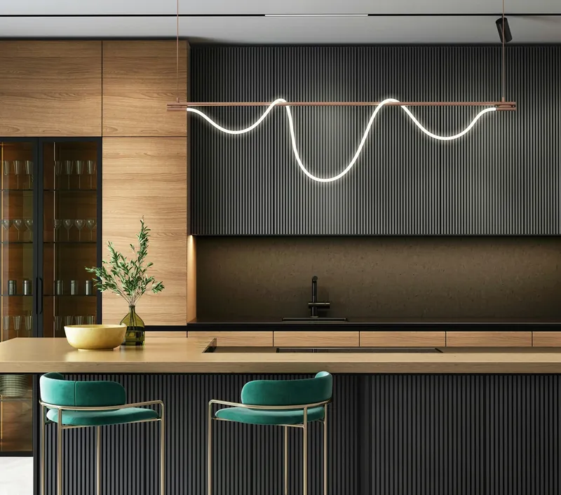 Dark fluted cabinetry and wood joinery behind a sculptural wave-form LED pendant and teal velvet bar stools